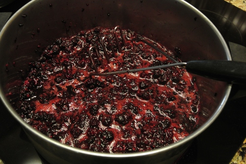 The mashed of dewberries coming up to a boil.