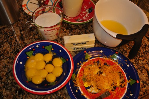 Yum - A plate of Lemon zest, 12 egg yolks, two sticks of butter, two cups of sugar and one generous cup of lemon juice. In the background is my sourdough starter bubbling away.